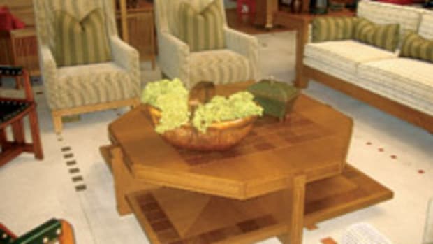 Lesch's Prairie-style coffee table has an octagonal top with square shelf. It was built with whit oak and white oak veneer. The inlaid tiles are made of stamped copper wrapped over a ceramic tile.