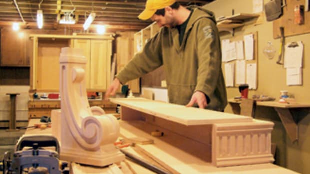 Russell Hudson Jr. assembles pieces for a fireplace mantle at his father's shop.