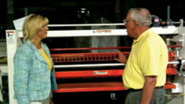 Skip Stachlewitz, COO of Black Bros. Co. in Mendota, Ill., discusses the features of the company's 775 adhesive spreader with Illinois state Sen. Sue Rezin as part of the WMMA's Patriot Award program.