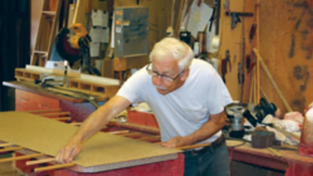 Alonzo Taylor glues a laminate countertop at Custom Woodwork Inc.