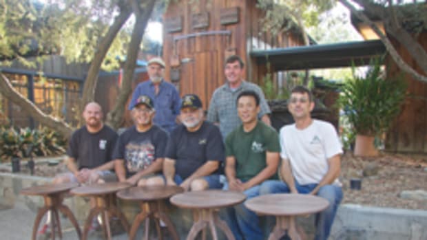 Veterans with their completed tables, made of walnut from Maloof's wood barn.