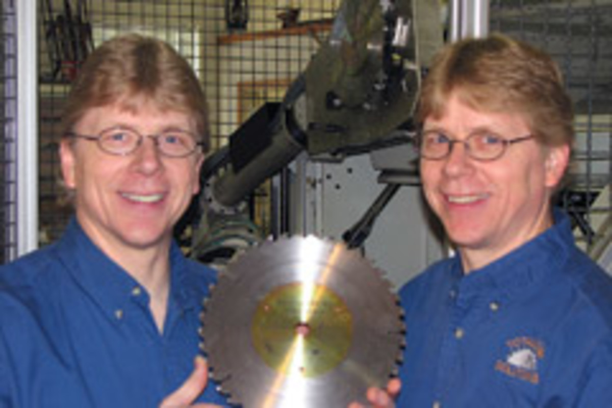 Don (left) and Ron Angelo, co-owners of Total Saw Solutions, with the company's new Micro-Kerf 40, a 10" table saw blade.