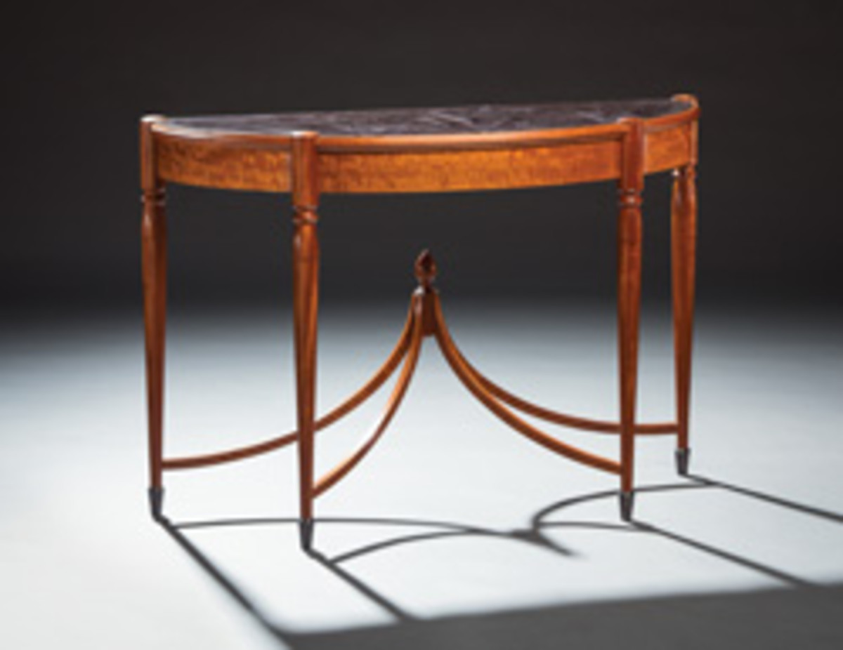 The “Our Stories” exhibit also features this demilune table by David Lamb.