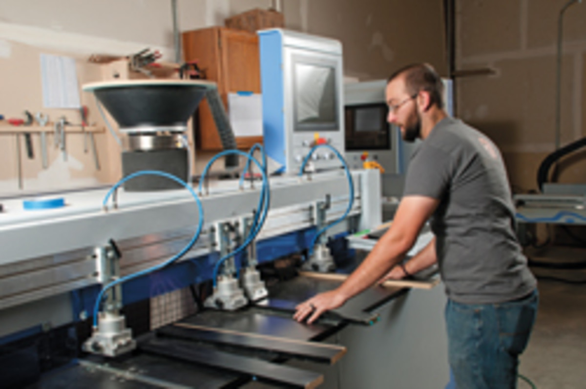 Chris Recker operates the shop’s Weeke ABD 050 automatic boring and doweller.