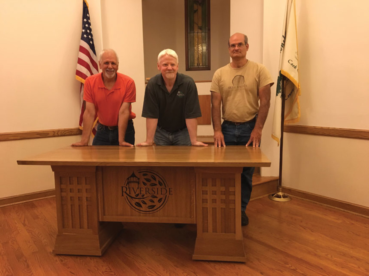 (From left) Paul Meyer, Michael Collins and Dan DeSerto with the finished tables.