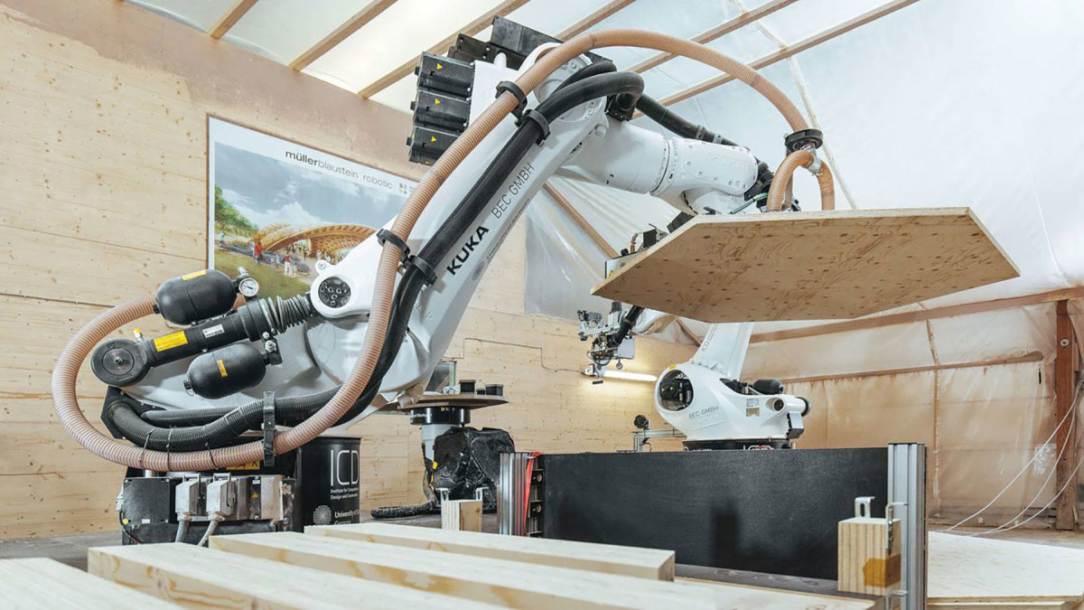 Two KUKA robots are seen here bonding and milling wooden panels for a University of Stuttgart project.