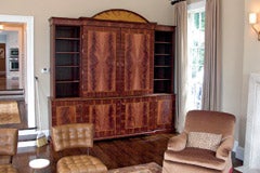 a-mahogany-wall-unit-with-bookmatched-crotch-mahogany-satinwood-inlays-and-pediment.jpg