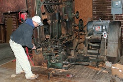 employee-tony-rickard-repairs-the-shops-1920s-mcdonough-reciprocating-resaw.jpg